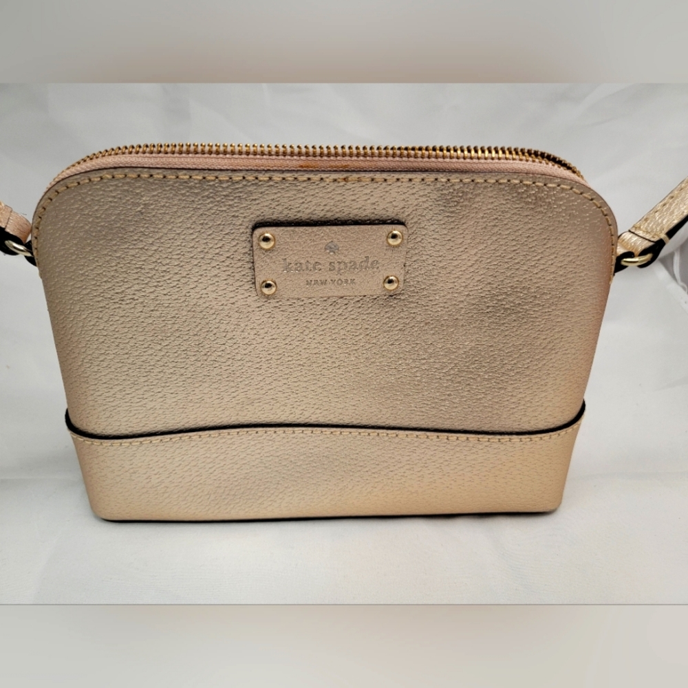 Kate spade crossbody gold shell with pink liner.